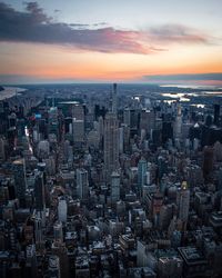 Aerial view of buildings in city during sunset