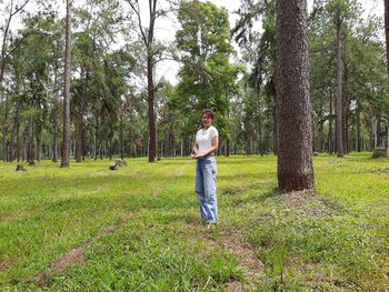 A young girl standing with a smile in the park