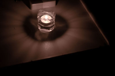 Close-up of illuminated light bulb in darkroom