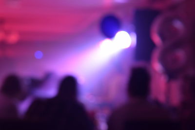 Blurred motion of people at music concert