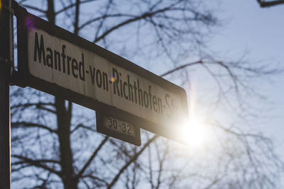 Low angle view of sign board against sky