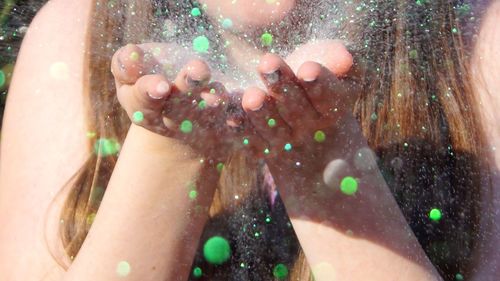 Close-up of wet hand in water