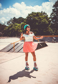 Cheerful woman skating at skateboard park