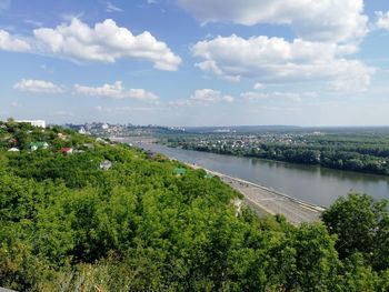 High angle view of trees and cityscape against sky