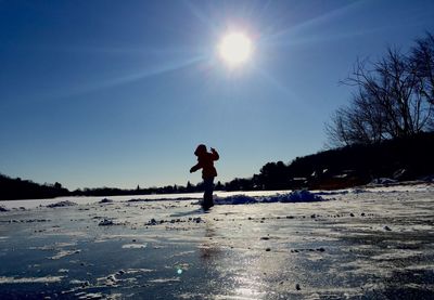 Silhouette of people on landscape at sunset