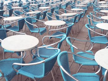 High angle view of empty chairs by table