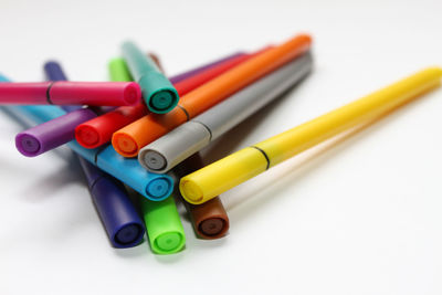 Close-up of colored pencils on white table