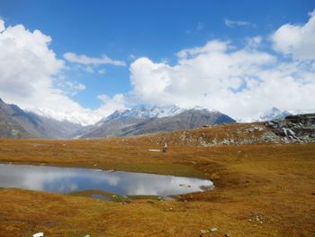 Scenic view of lake and mountains against sky
