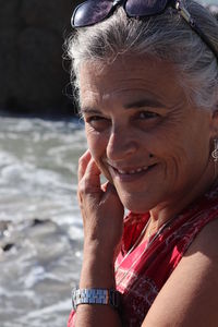 Close-up portrait of smiling woman with water