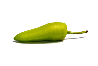 Close-up of green chili pepper against white background