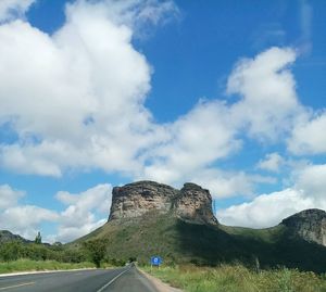 Road by mountain against sky