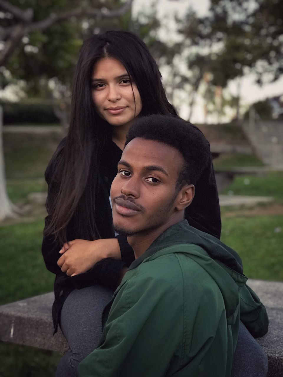 portrait, young adult, looking at camera, young men, real people, two people, lifestyles, young women, leisure activity, people, togetherness, standing, focus on foreground, adult, women, headshot, men, emotion, bonding, day, couple - relationship, positive emotion, outdoors