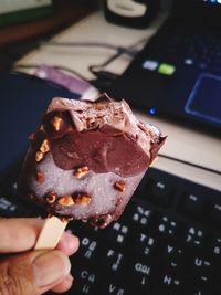 Close-up of hand holding ice cream cone