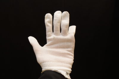 Close up of hand against black background