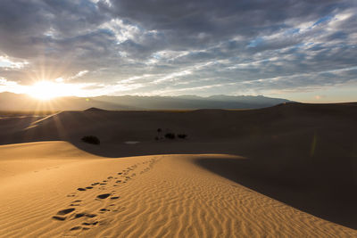 Scenic view of desert against sky during sunset