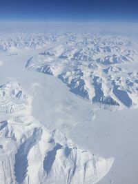 Aerial photo of a snow and ice landscape with mountains 