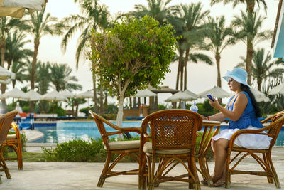 Young woman sitting on chairs