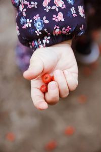 Close-up of hand holding girl