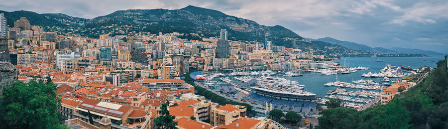 High angle view of townscape by sea against sky