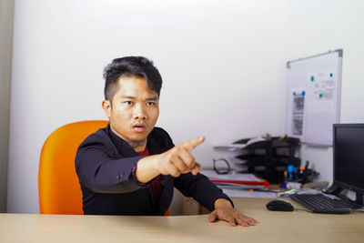 Portrait of man working on table