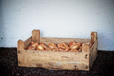 Close-up of bread on table against wall