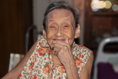 Portrait of woman sitting on chair at home