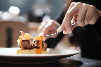 Melted egg cut by woman hand