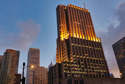 Low angle view of illuminated buildings against sky - nbc tower - chicago