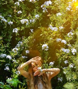 Young woman with flowers on tree