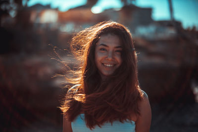 Portrait of beautiful young woman with long brown hair