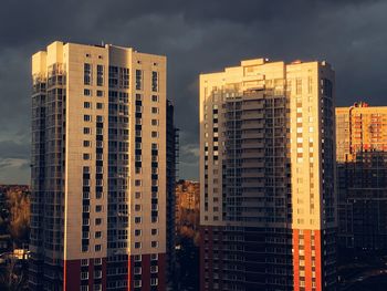 Low angle view of modern buildings in city against sky