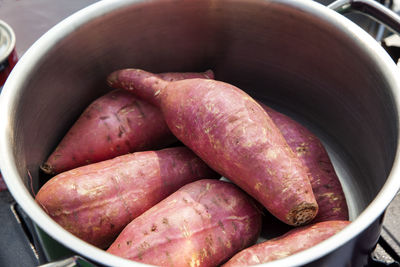 High angle view of sweet potatoes in container