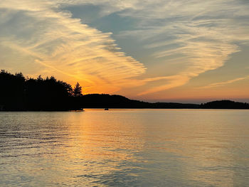 Scenic view of lake against orange sky