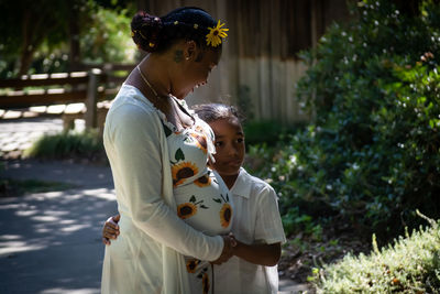 Side view of woman with child 