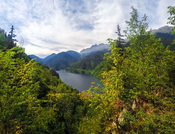 Scenic view of lake and mountains against sky