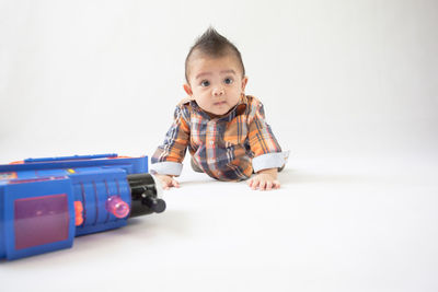 Portrait of cute boy against white background