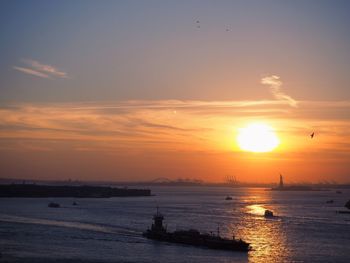 Scenic view of sea against romantic sky at sunset