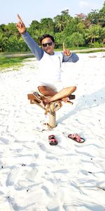 Portrait of young man sitting on beach