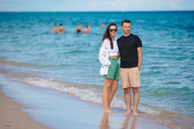 Young woman standing at beach