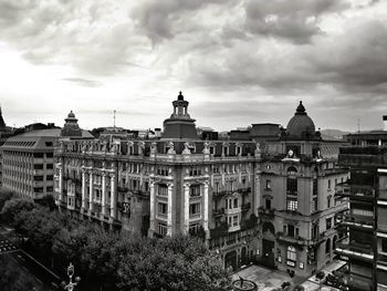 High angle view of buildings against cloudy sky