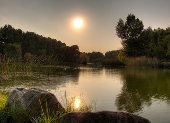 Scenic view of lake at sunset