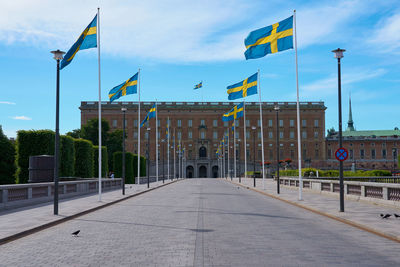 Flag on building against cloudy sky
