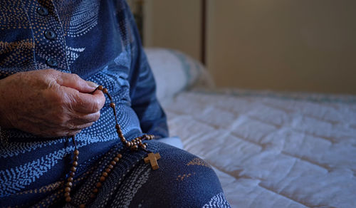 Midsection of woman sitting at home