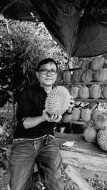 Portrait of man holding fruit at market
