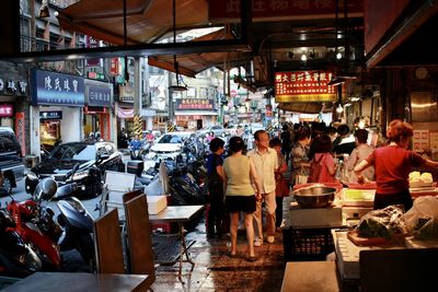 People at market stall in city