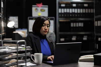 Young woman using laptop at table