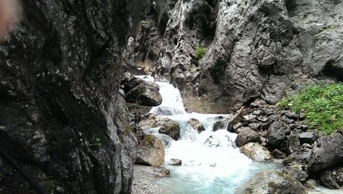 Stream flowing through rocks in forest