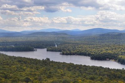 Scenic view of lake and mountains against sky