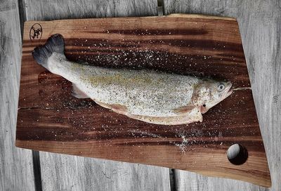 High angle view of fish on cutting board