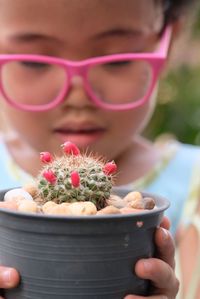 Cute girl holding potted plant